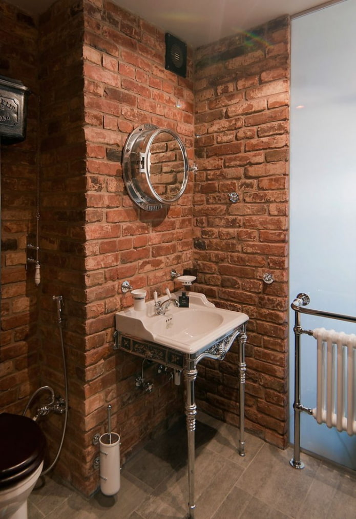 toilet with brick walls