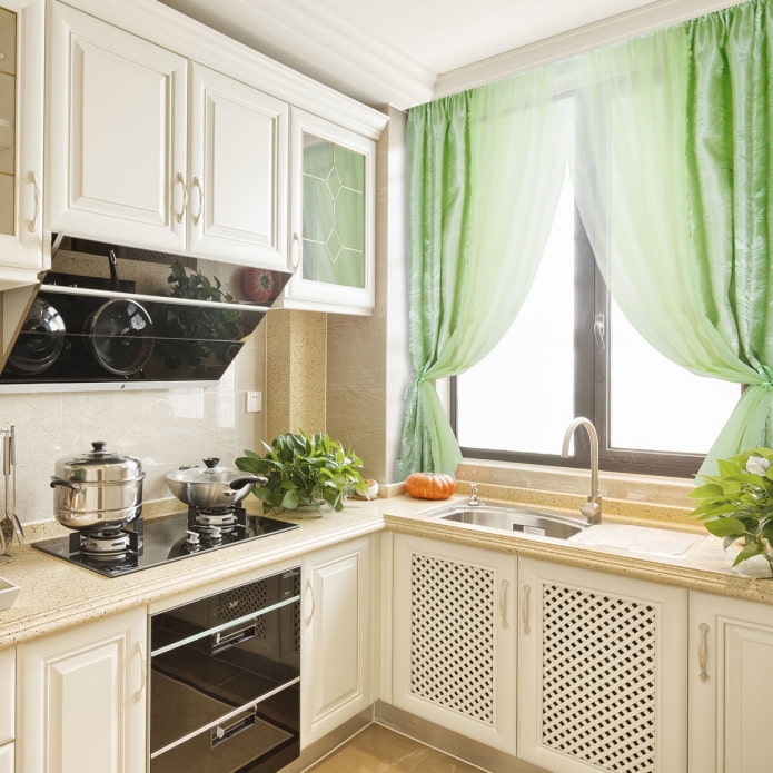 curtains in the kitchen with a sink by the window
