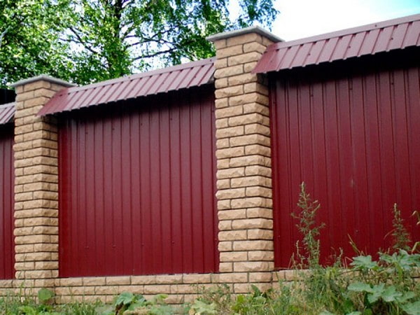 Burgundy corrugated fence with a ridge