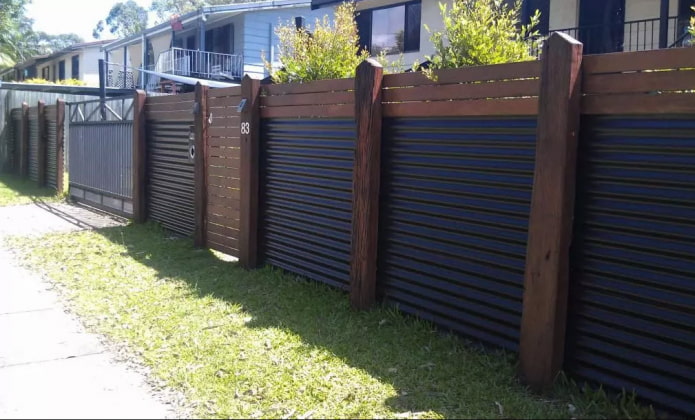 Fence made of profiled sheet with wooden posts