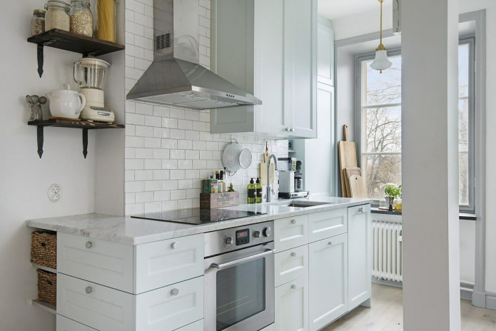 White kitchen with a box in the center of the wall