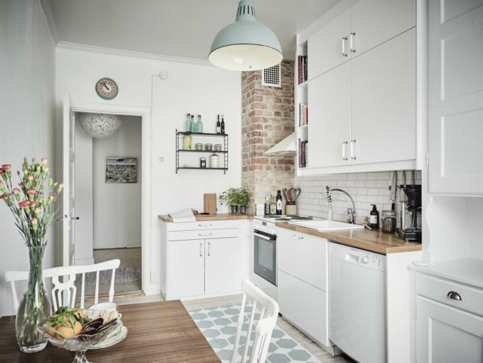 White kitchen with a brick-decorated ventilation box