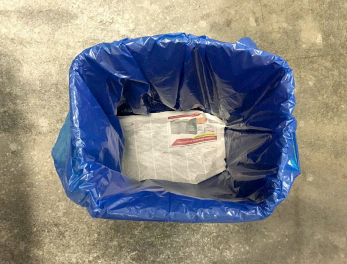 Newspaper at the bottom of the trash bag
