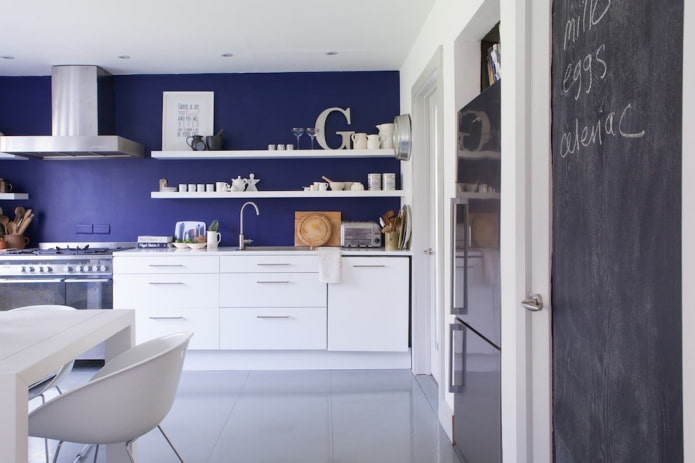 Blue wall, white cabinets and shelves
