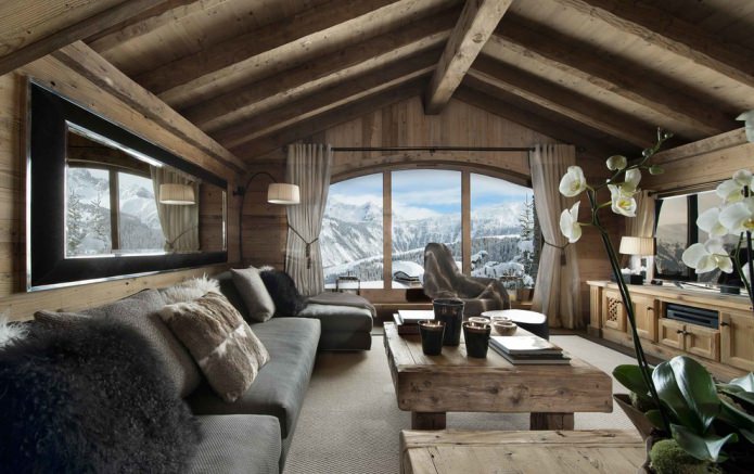 natural materials, wood wall decoration, beams on the ceiling, wooden furniture and pillows made of skins and fur