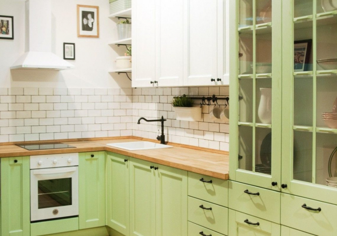 green kitchen with black handles