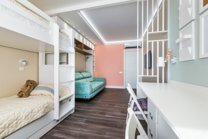 narrow nursery with a sofa and two beds