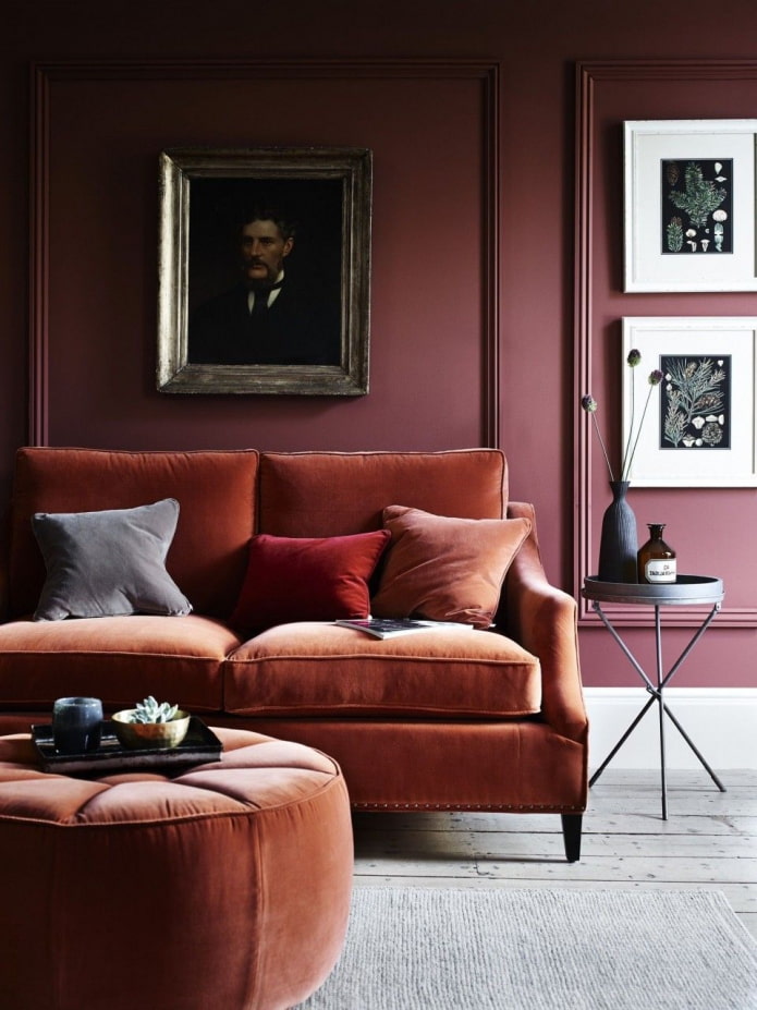 burgundy wall with orange sofa