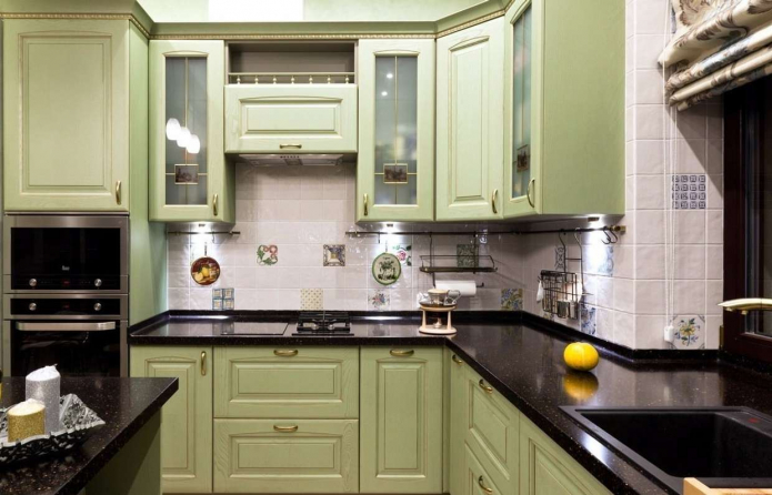 green kitchen with black countertop