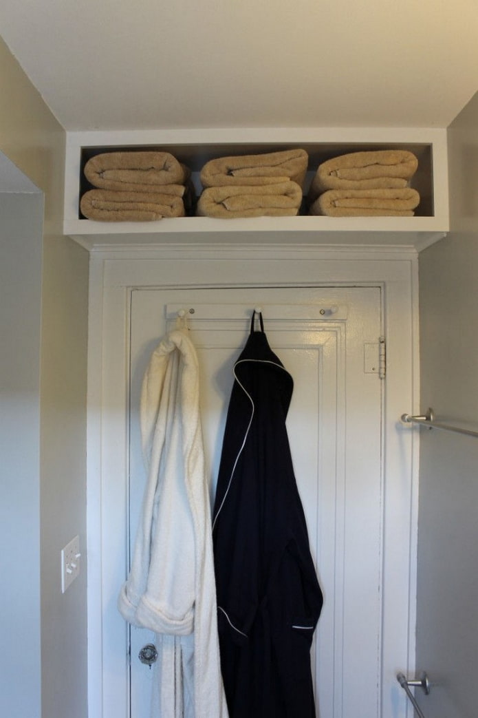 shelf with towels above the door