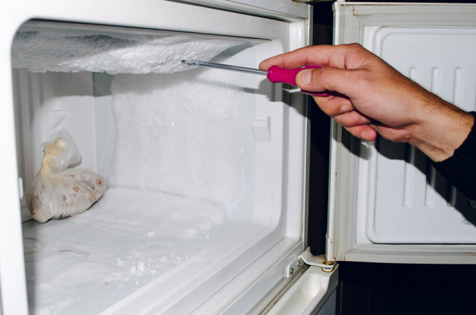 chipping ice in the freezer