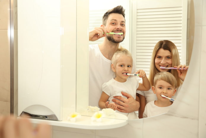 the whole family is brushing their teeth