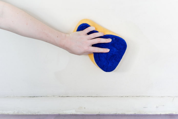 cleaning the wall with a soft sponge