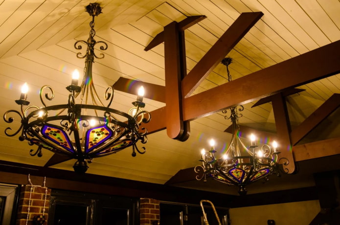 wrought iron chandeliers on the wooden ceiling