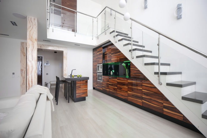 modern kitchen built into the flight of stairs