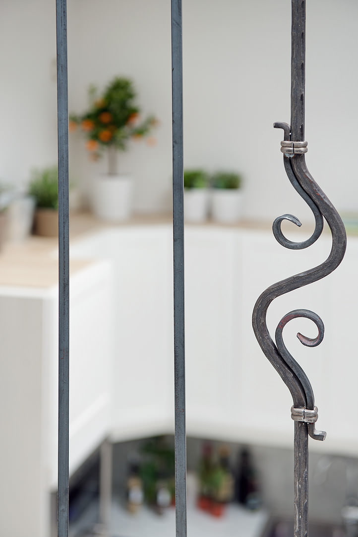 forged railings in a mansard-type apartment