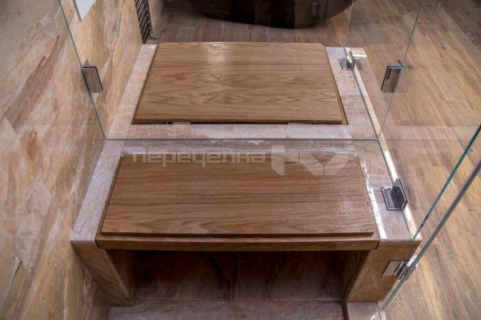 bench in the shower cabin in the design of a large bathroom