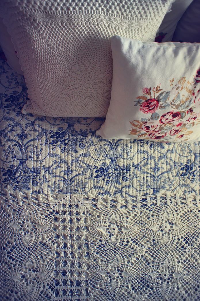 lace pillows and bedspread in rustic bedroom