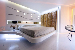 Floating bed in the interior: types, shapes, design, backlit options